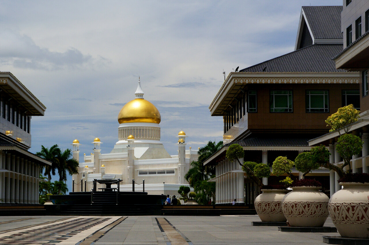 The golden dome of the Sultan Omar Ali Saifuddien Mosque reflected in its lagoon in Bandar Seri Begawan
